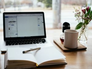 work setup for blogger experience including laptop, notebook